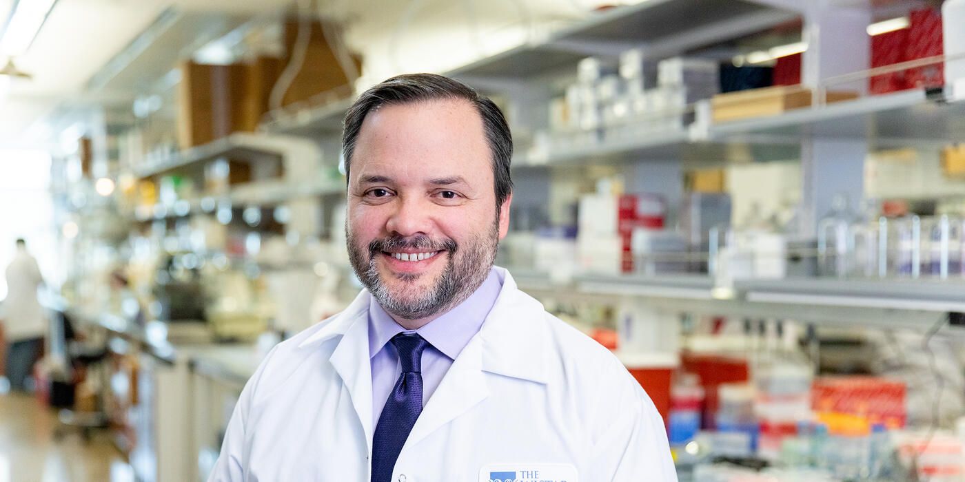 Scientist Luis Montaner smiles in a Wistar lab