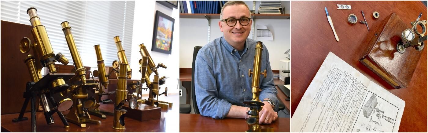 Dr. Italo Tempera poses at his desk with one of his antique microscopes