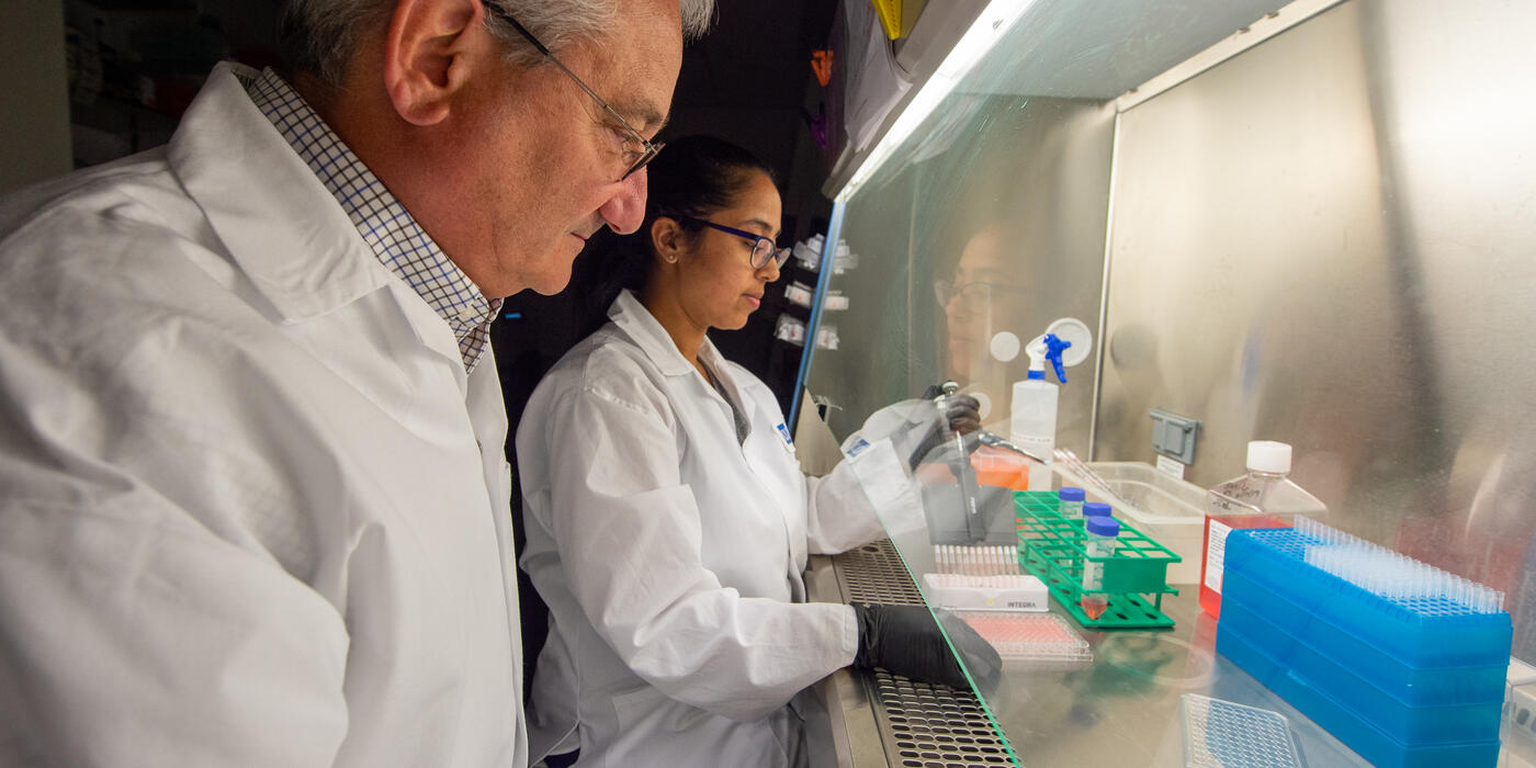 Drs. David Weiner and Ami Patel working at a hood in the lab