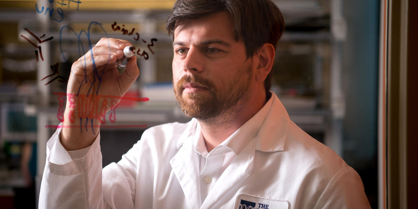 Dr. Daniel Kulp writes on a whiteboard